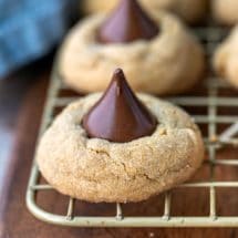Peanut butter kiss cookies on a gold wire cooling rack