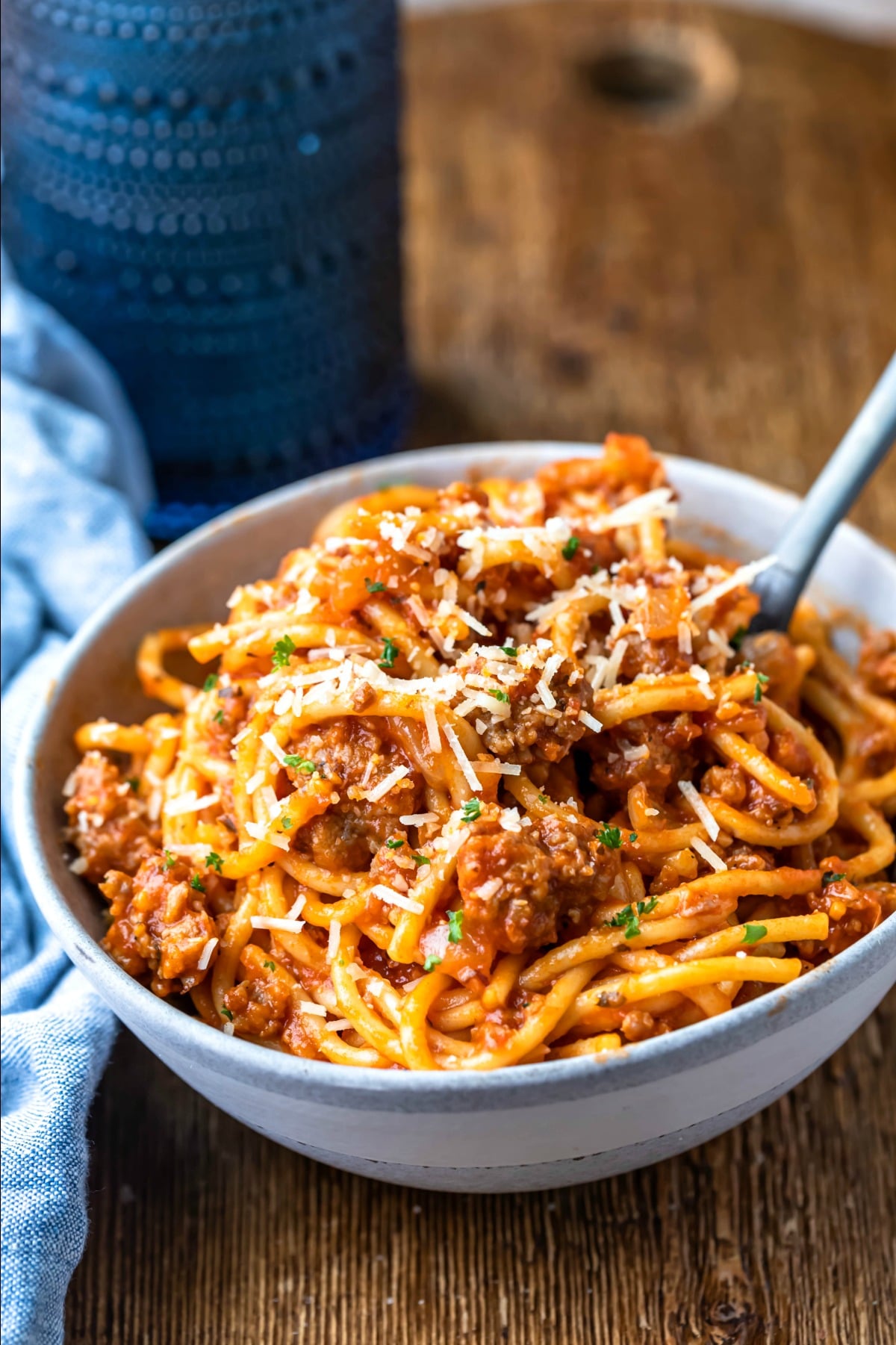 Blue stoneware dish of spaghetti and meat sauce