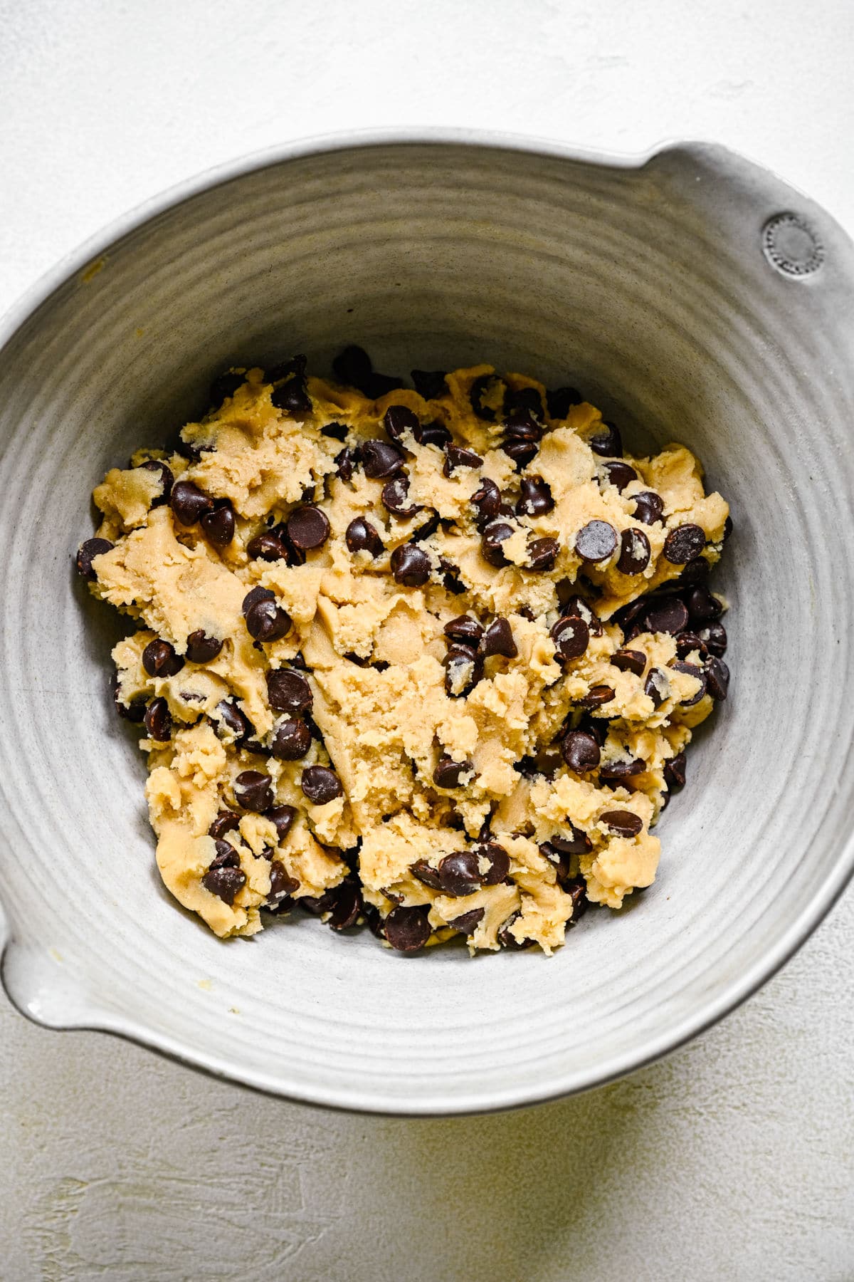 Chocolate chip cookie dough in a mixing bowl.