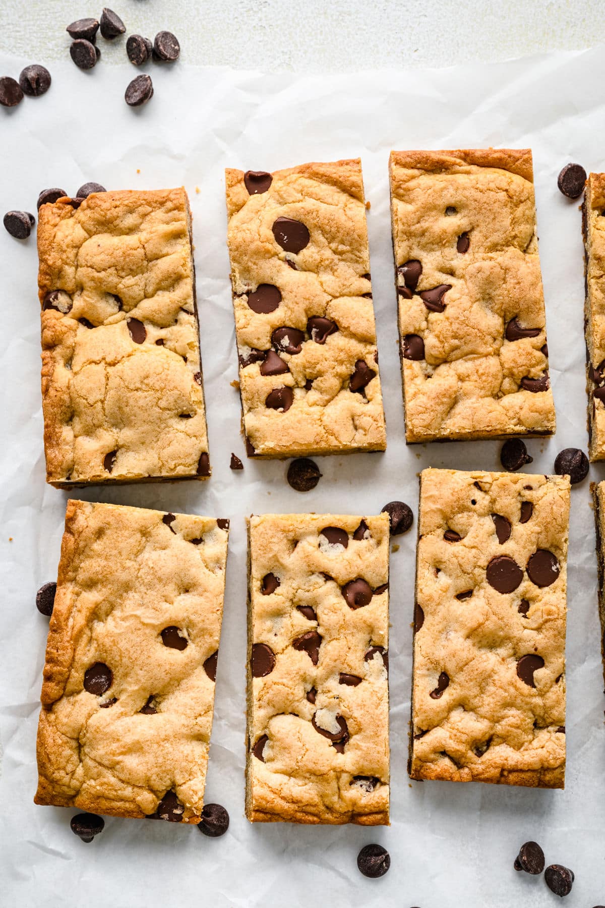Chocolate Chip Cookie Bar Recipe Chocolate chip cookie bars in rows on a piece of parchment paper.