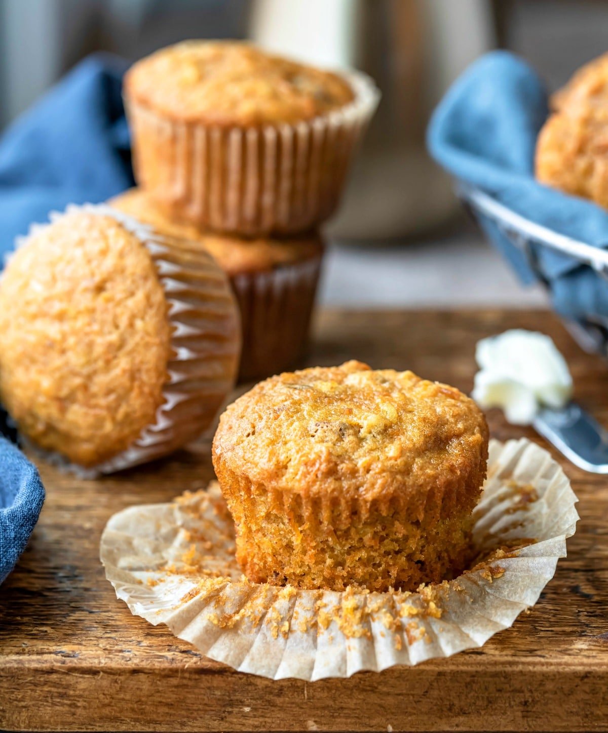 Carrot cake muffin next to three carrot cake muffins