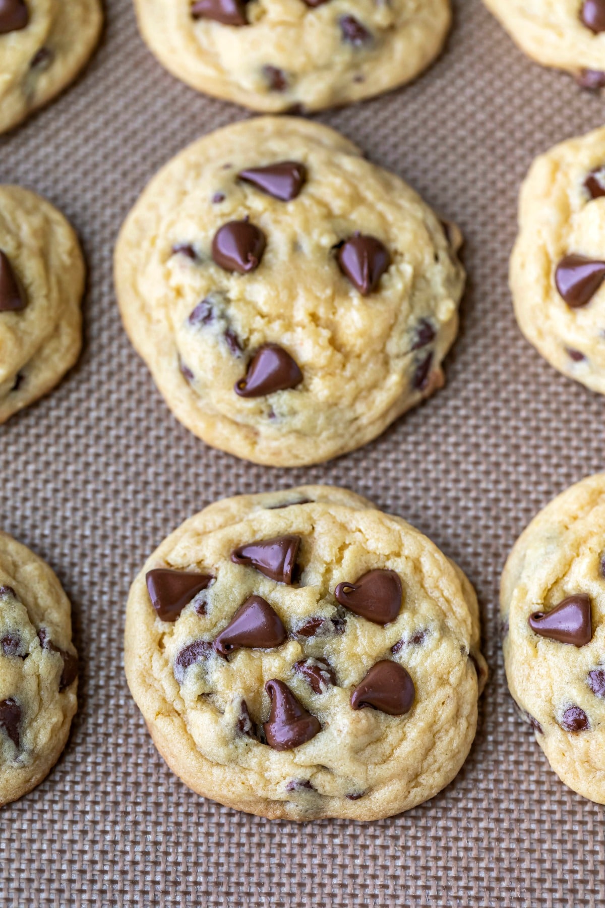 Chocolate chip pudding cookies on a silicone baking mat