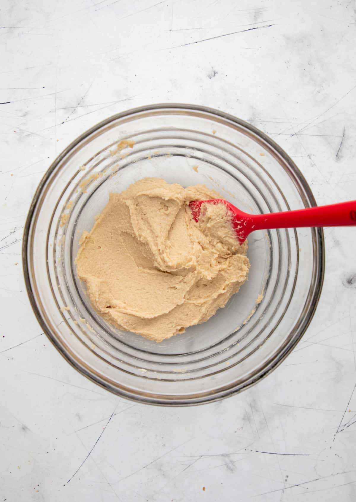 Chocolate chip pudding cookie dough without chocolate chips in it in a mixing bowl. 