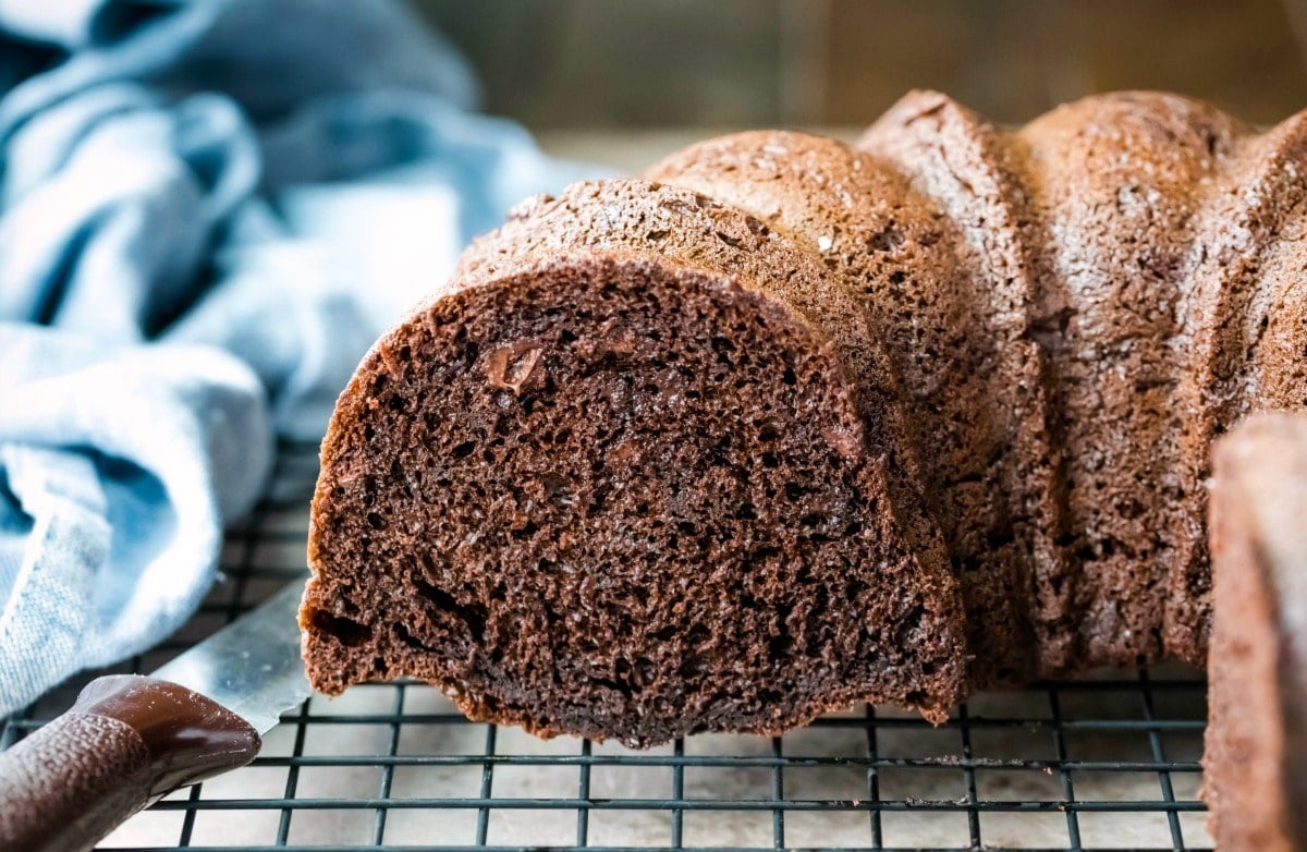 Darn good chocolate cake next to a serrated knife