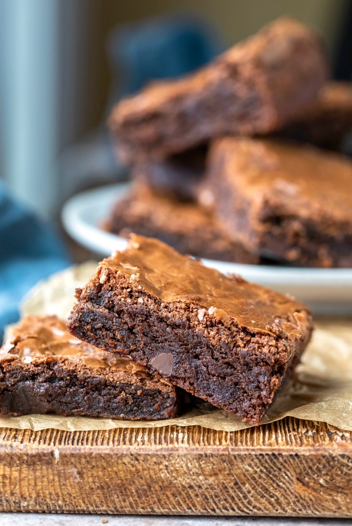 Two Mexican brownies stacked on top of each other on a piece of brown parchment paper. 