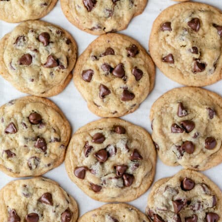 Rows of chocolate chip pudding cookies on a piece of parchment paper.