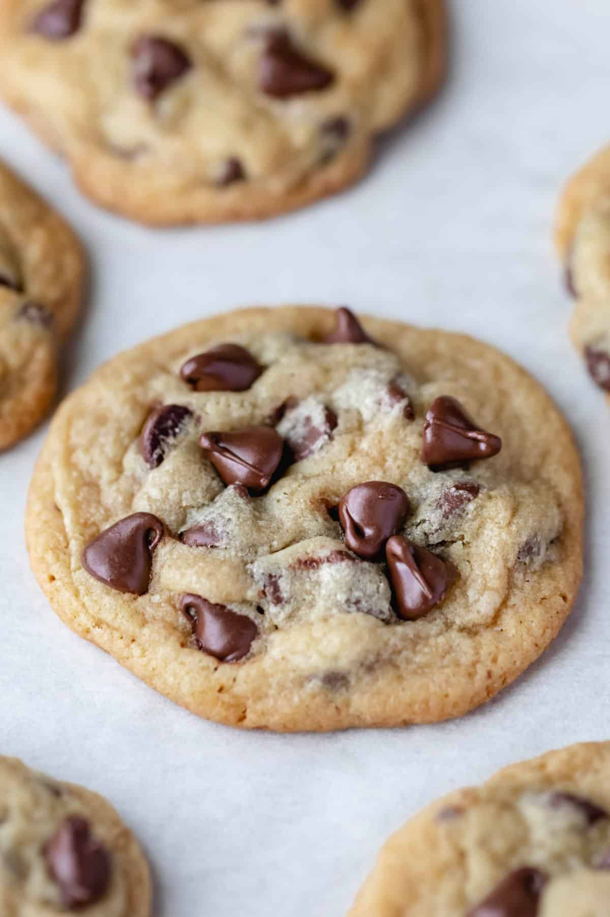 Chocolate chip pudding cookies on a piece of parchment paper.