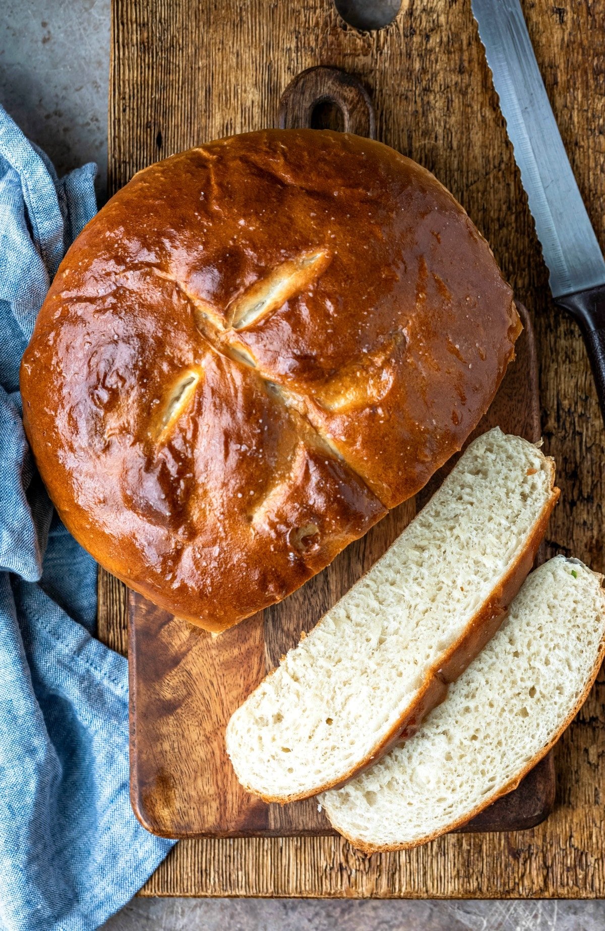 Two slices of bread next to a loaf of skillet bread