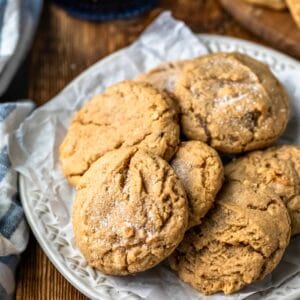 Plate of chewy peanut butter cookies on a wooden cutting board