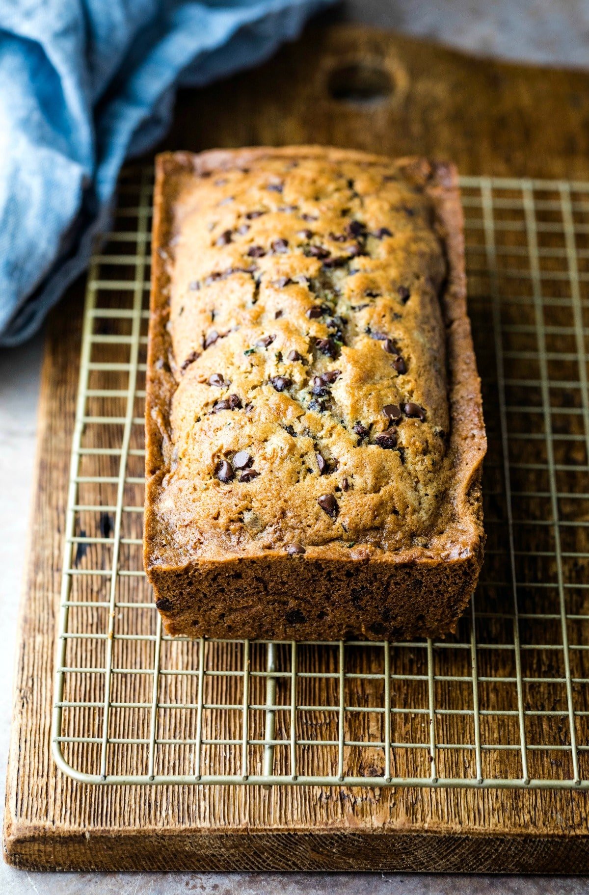 Loaf of chocolate chip zucchini bread on a wire cooling rack