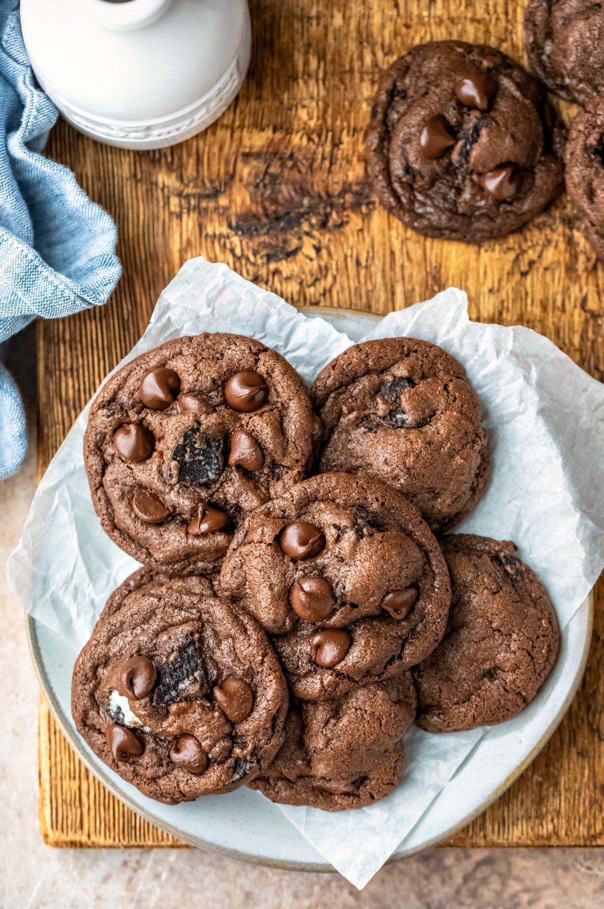 Plate of chocolate oreo cookies on a wooden cutting board