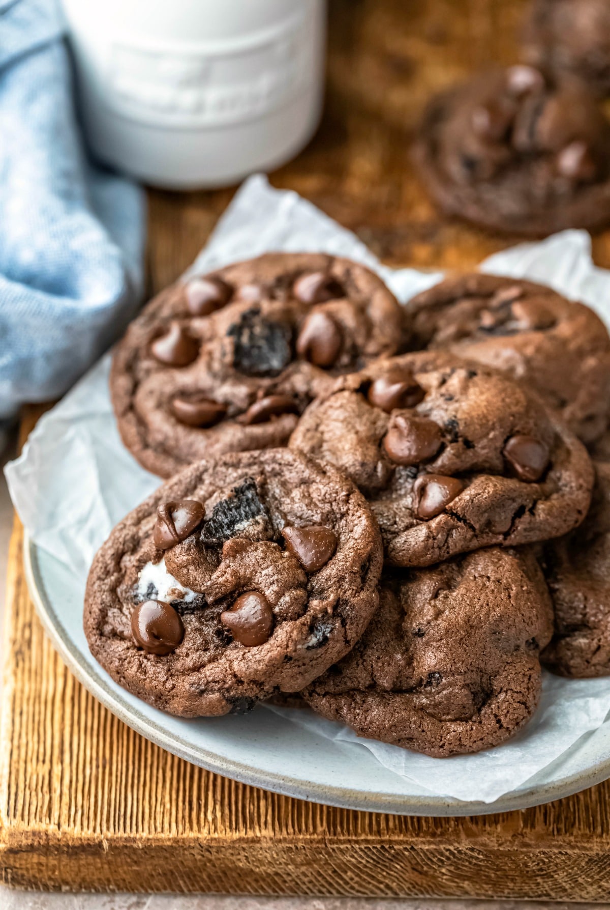 Plate of chocolate oreo cookies next to a bottle of milk