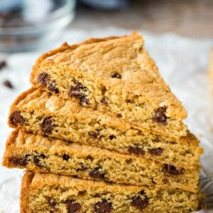 Slices of chocolate chip cookie cake stacked on top of each other