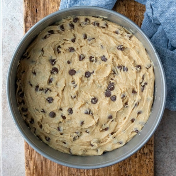 Chocolate chip cookie dough batter in springform pan