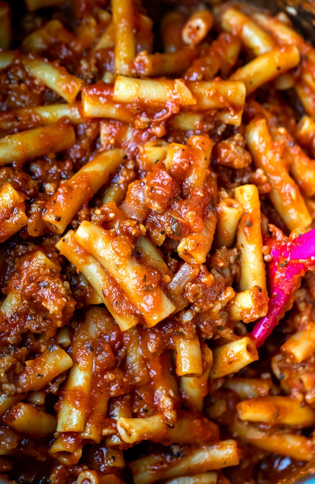 Close photo of spoon stirring Instant Pot ziti