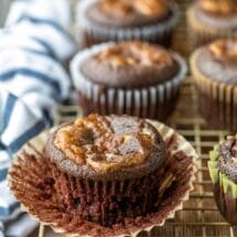 Chocolate cheesecake cupcake on a gold wire cooling rack