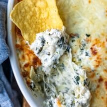 Tortilla chip topped with spinach artichoke dip