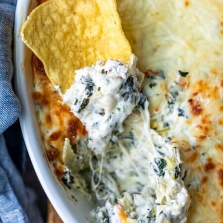 Tortilla chip topped with spinach artichoke dip