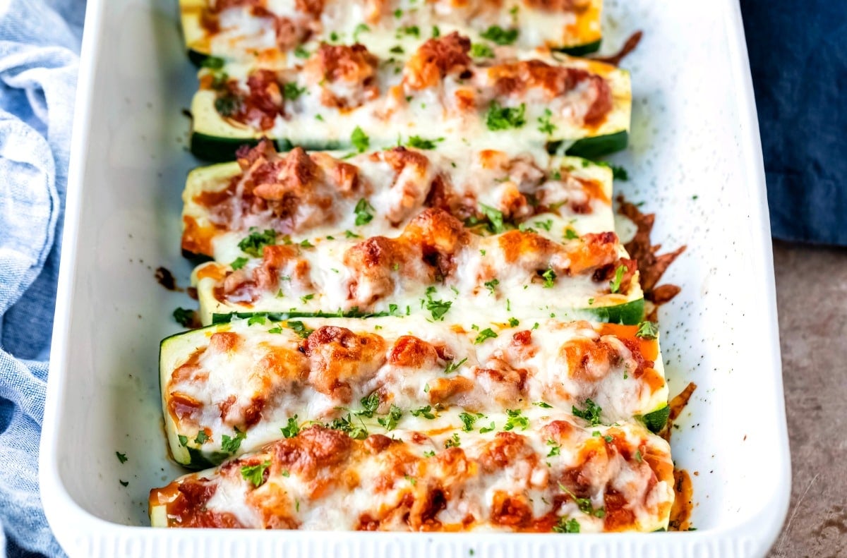 Baked zucchini boats in a white baking dish
