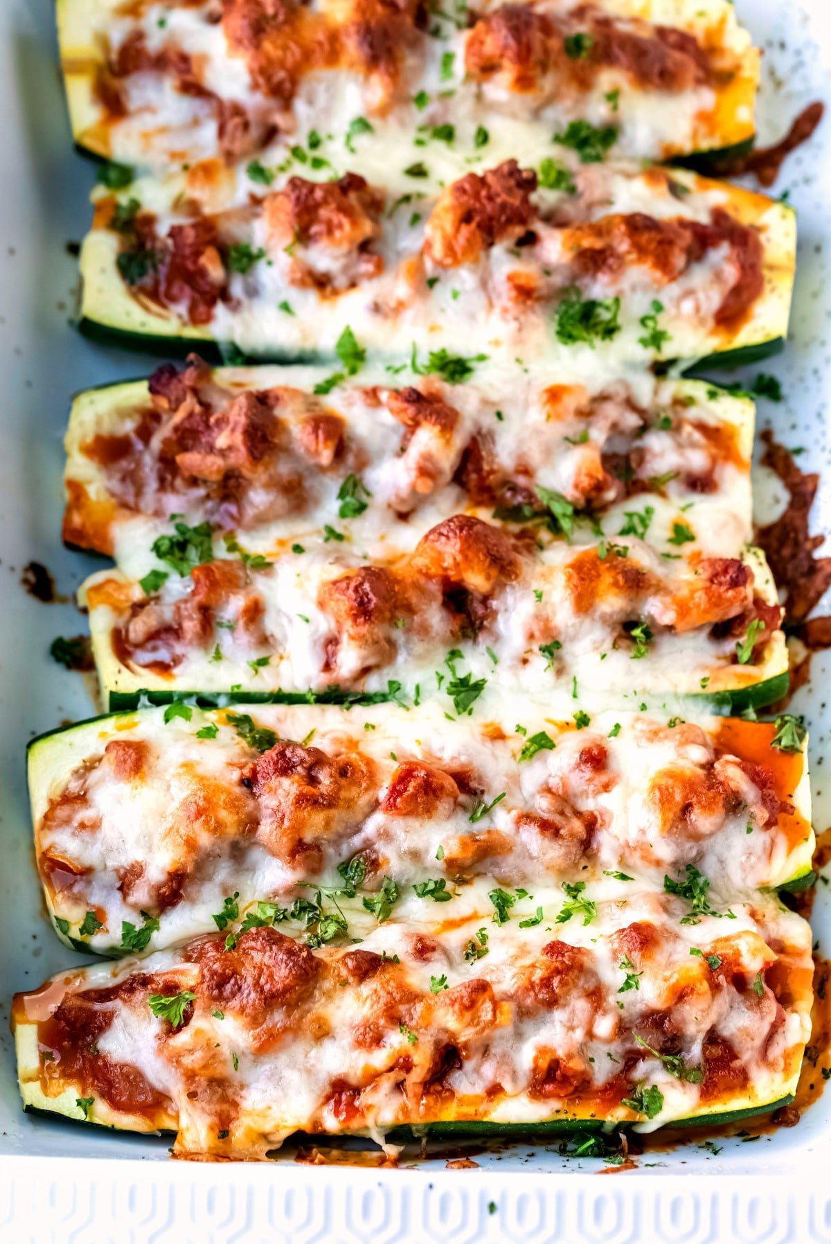 Zucchini boats filled with sausage sauce and cheese