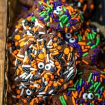 Halloween monster cookies in a black metal tin