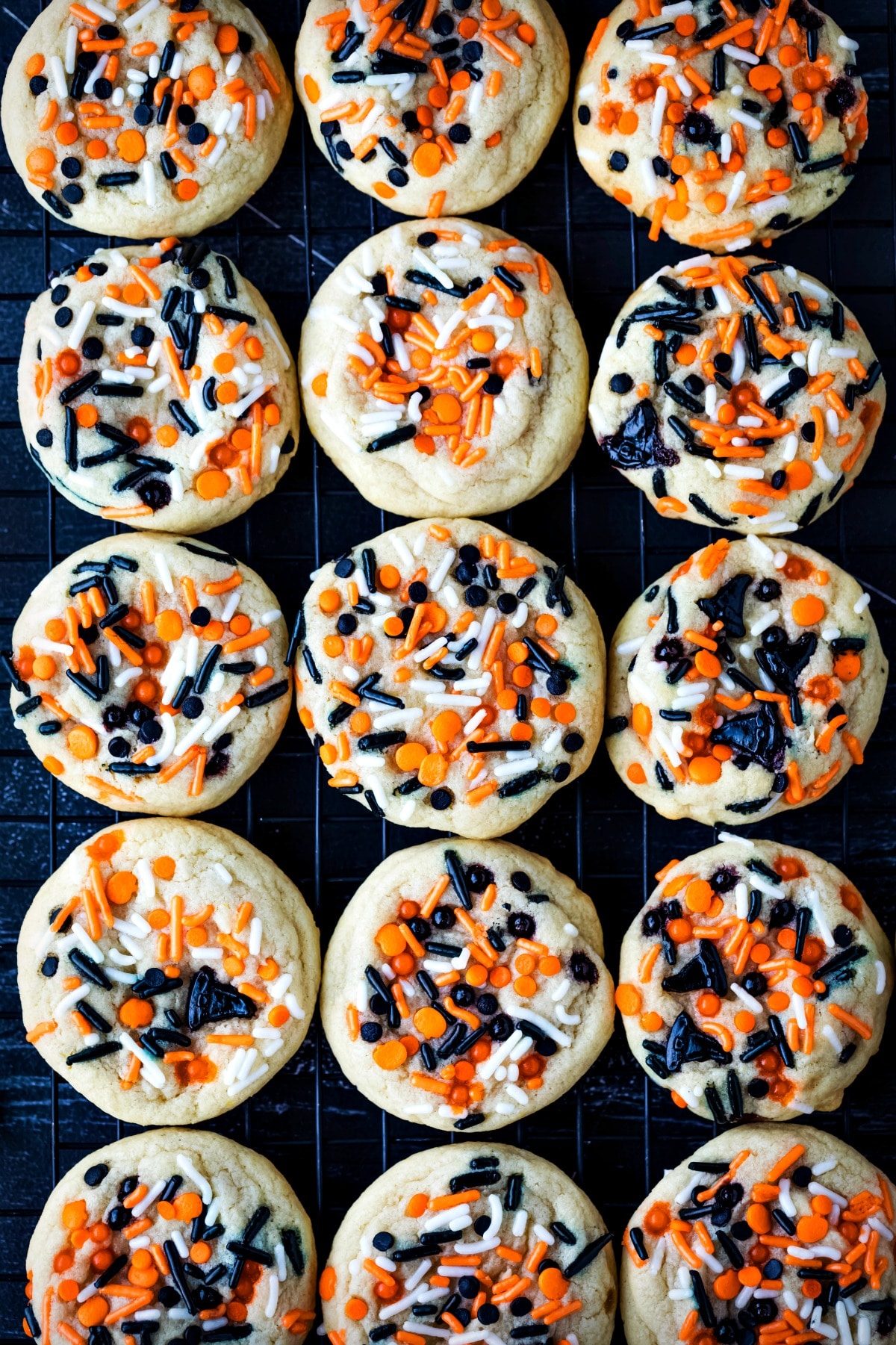 Halloween Sprinkle Cookie Recipe Halloween sprinkle cookies on a black wire cooling rack