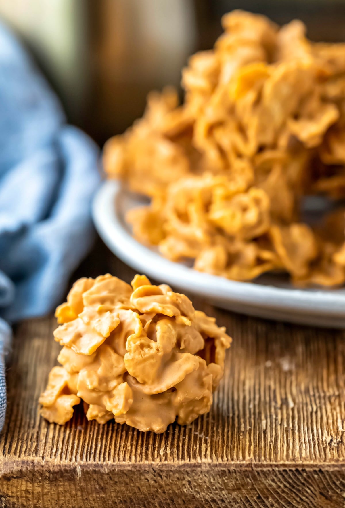 Butterscotch cornflake cookie next to a plate of cookies