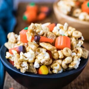 Halloween snack mix in a black wooden bowl