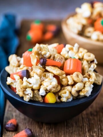 Halloween snack mix in a black wooden bowl