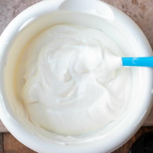 Sour cream topping in a white mixing bowl.