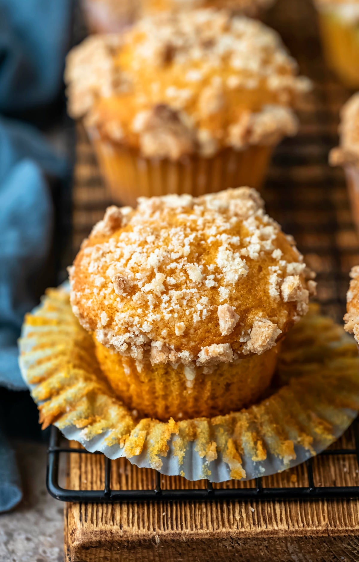 Pumpkin Streusel Muffins on a black wire cooling rack