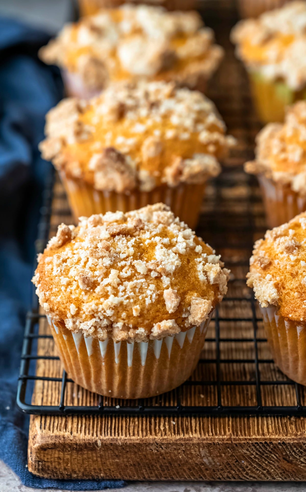 Row of pumpkin streusel muffins on a wooden cutting board