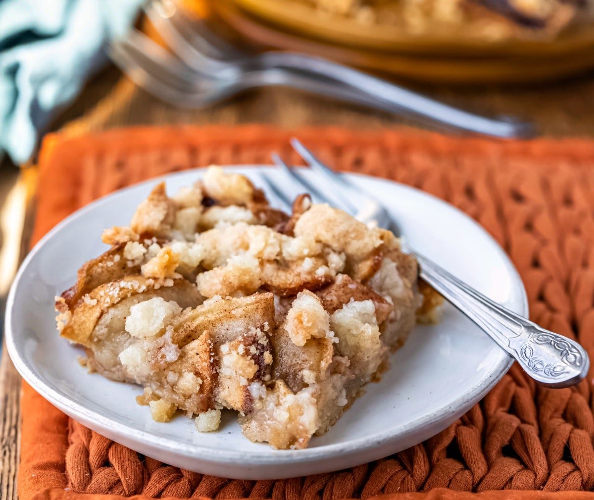 White plate with a piece of apple crumb bar on it