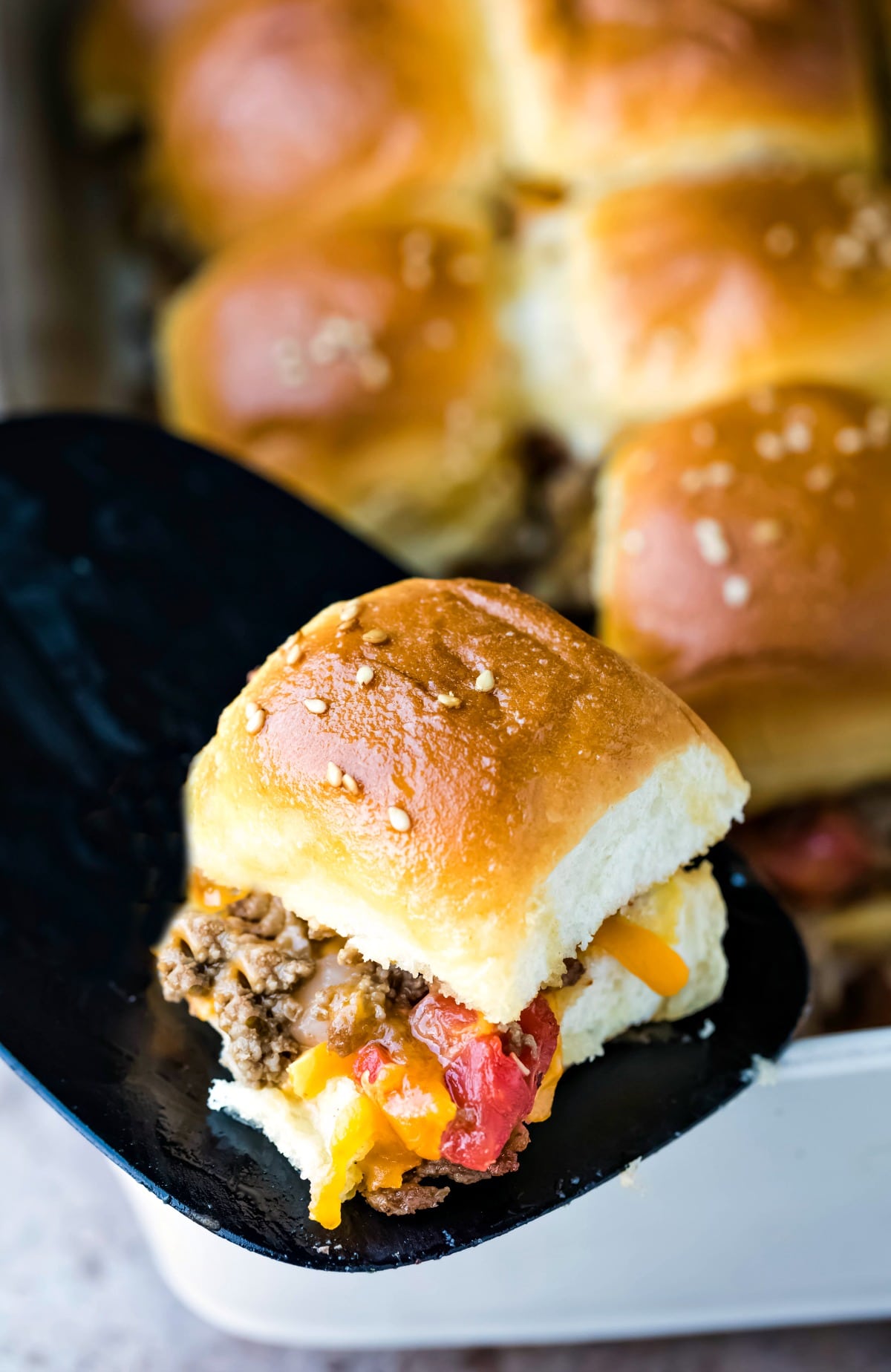 Cheeseburger slider on a black spatula