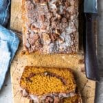 Loaf of cinnamon sugar pumpkin bread on a marble cutting board