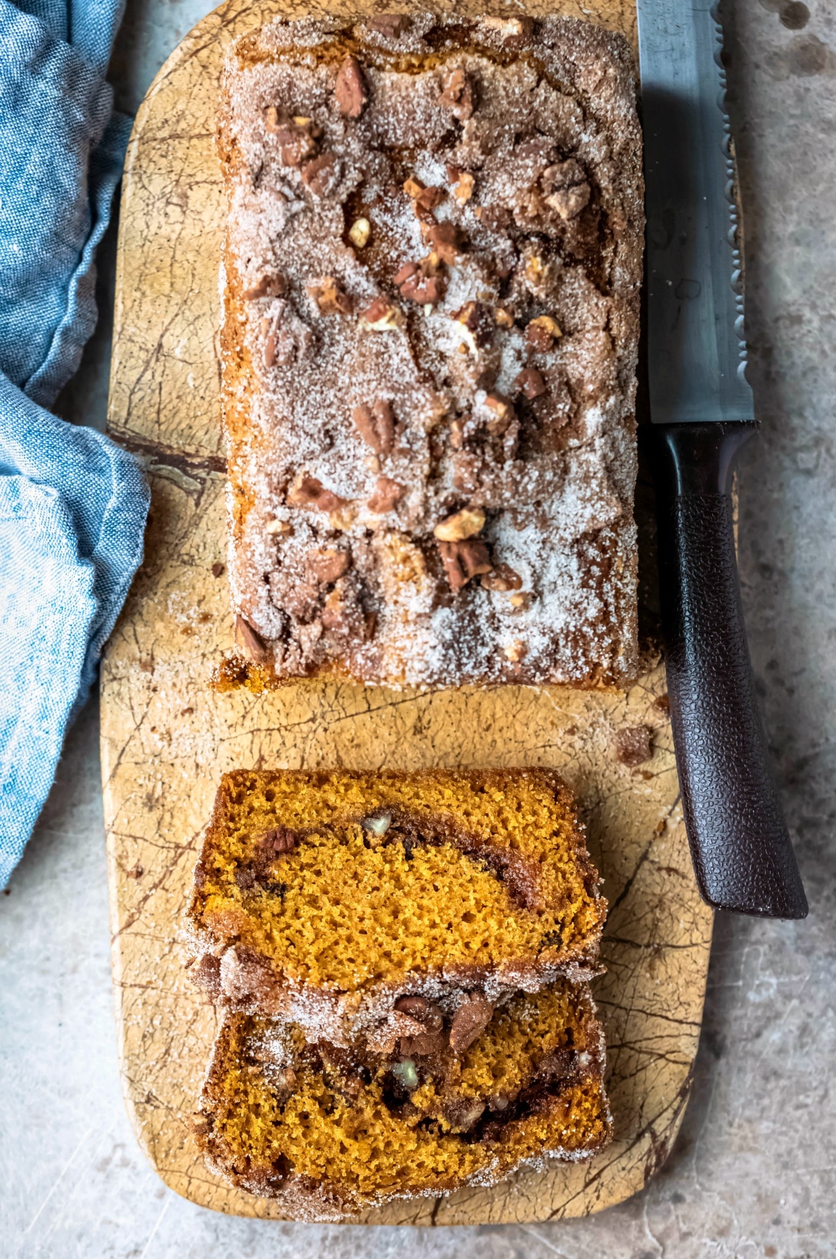 Loaf of cinnamon sugar pumpkin bread next to a bread knife