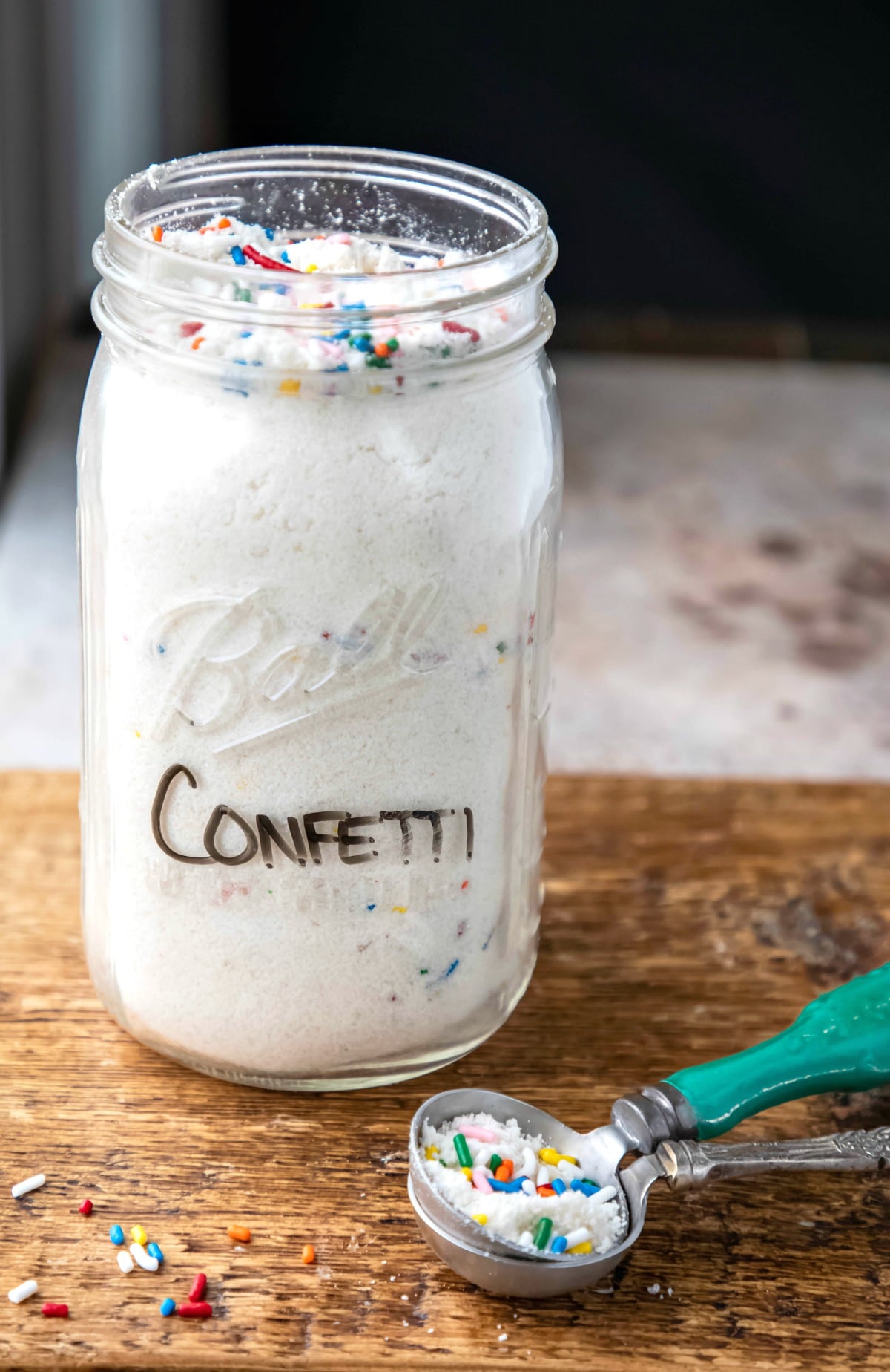 Homemade confetti cake mix in a glass jar.