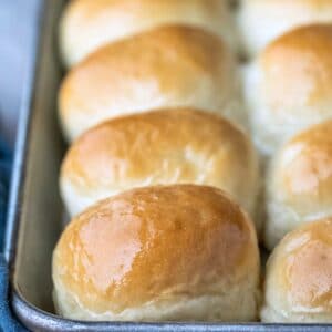 Silver baking tray with a row of one hour dinner rolls on it