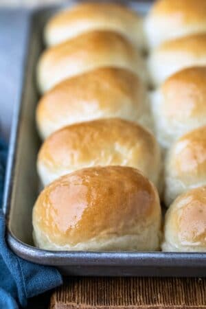 Silver baking tray with a row of one hour dinner rolls on it
