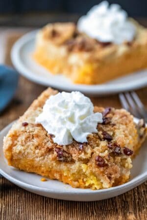 Two slices of pumpkin pie cake on white plates