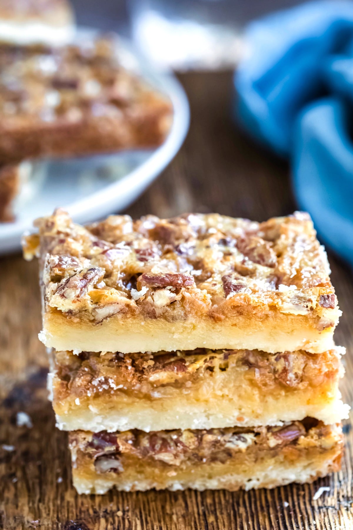 Three toffee pecan pie bars stacked on each other