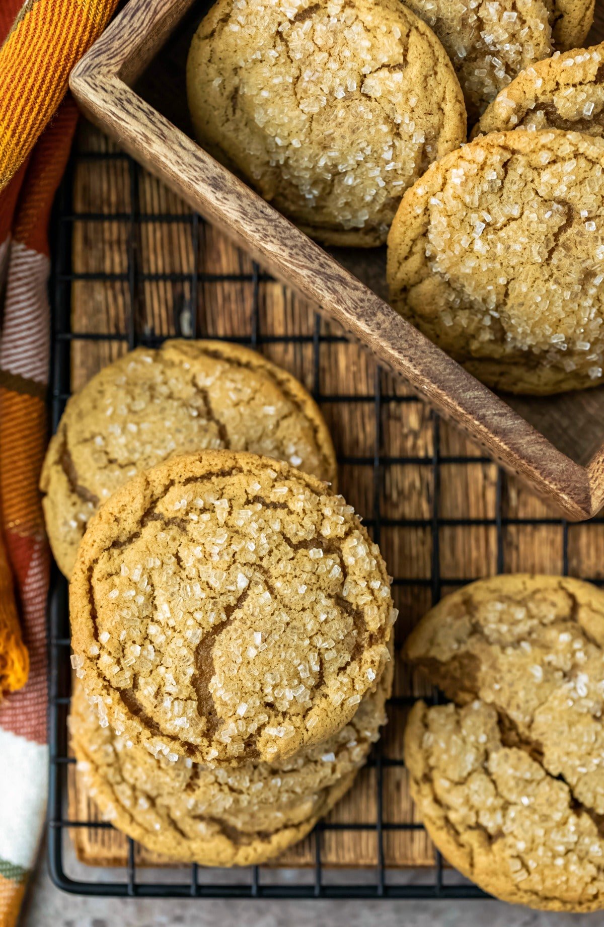stack of ginger molasses cookies on a black metal baking rack