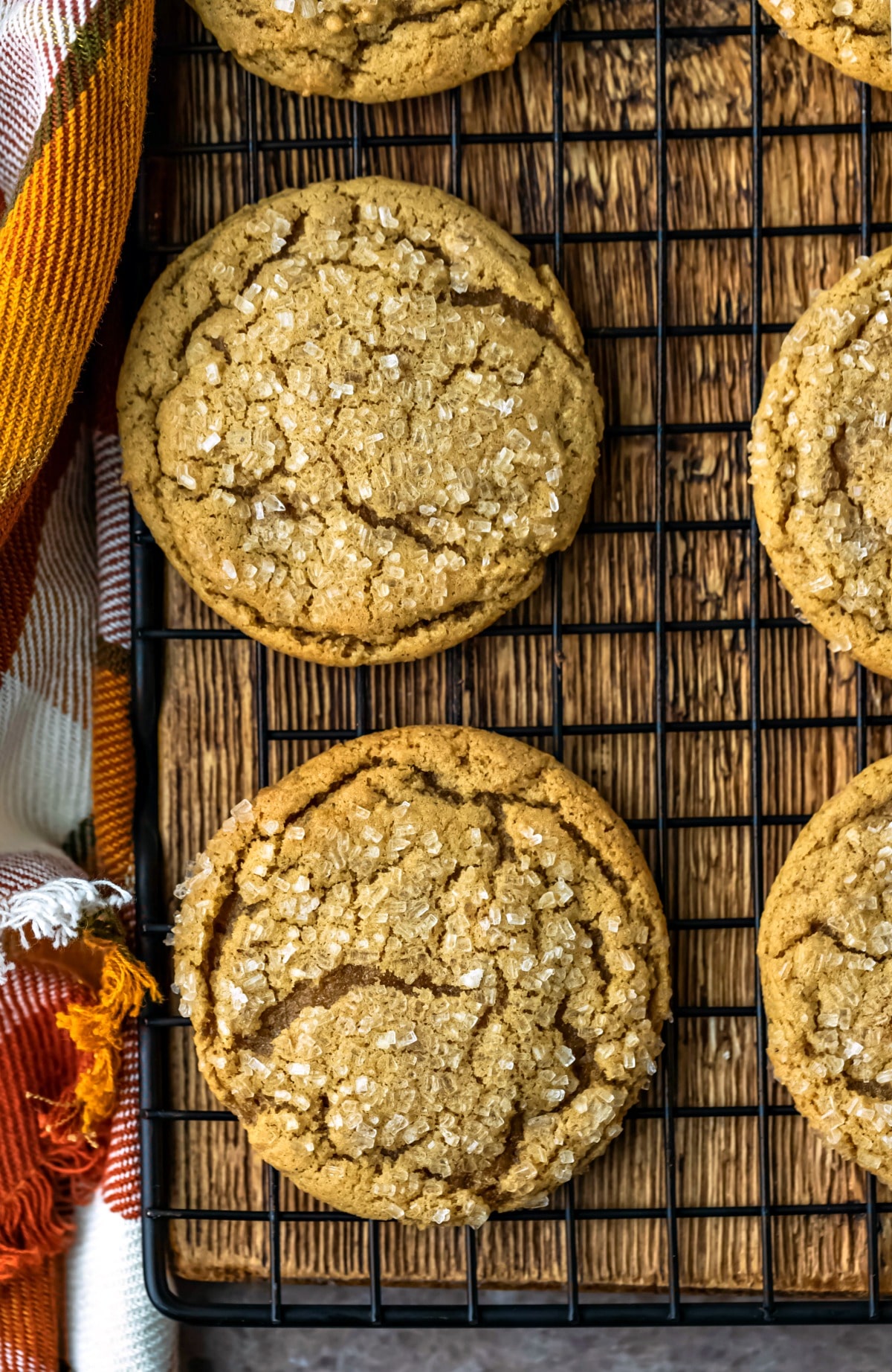 Overhead photo of ginger molasses cookies on a wire cooling rack