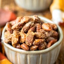 Two pottery ramekins filled with roasted glazed cinnamon almonds