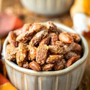 Two pottery ramekins filled with roasted glazed cinnamon almonds