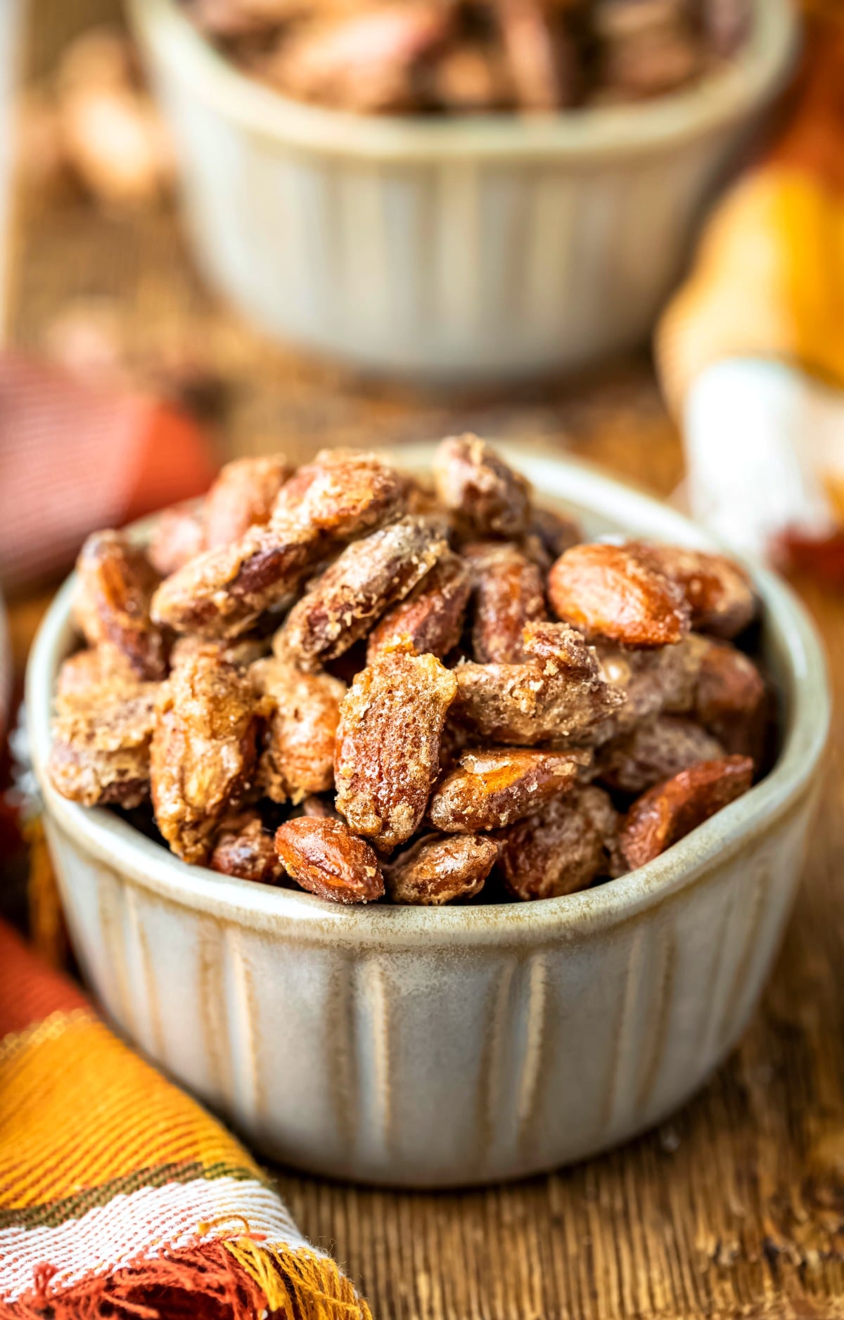 Two pottery ramekins filled with roasted glazed cinnamon almonds