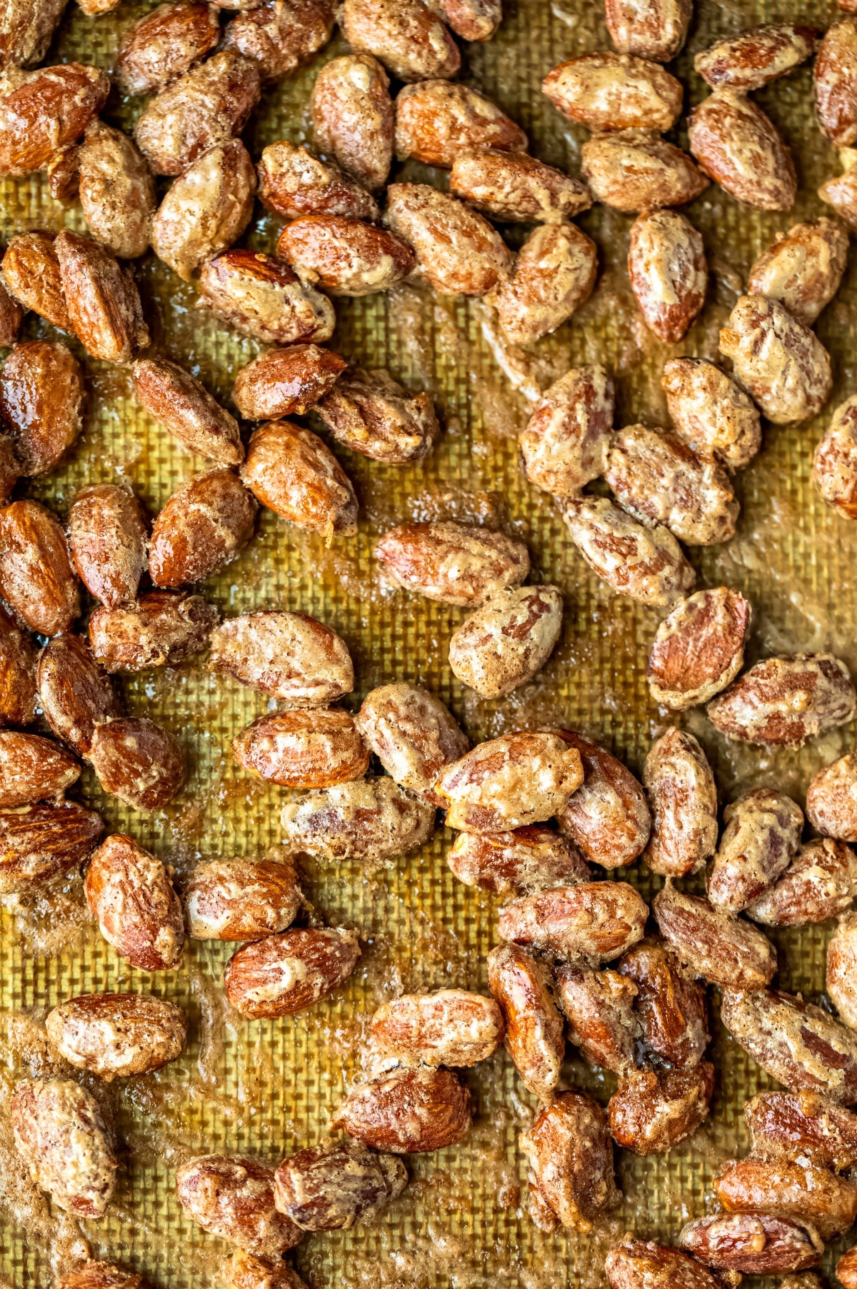 Baked cinnamon almonds on a silicone baking mat