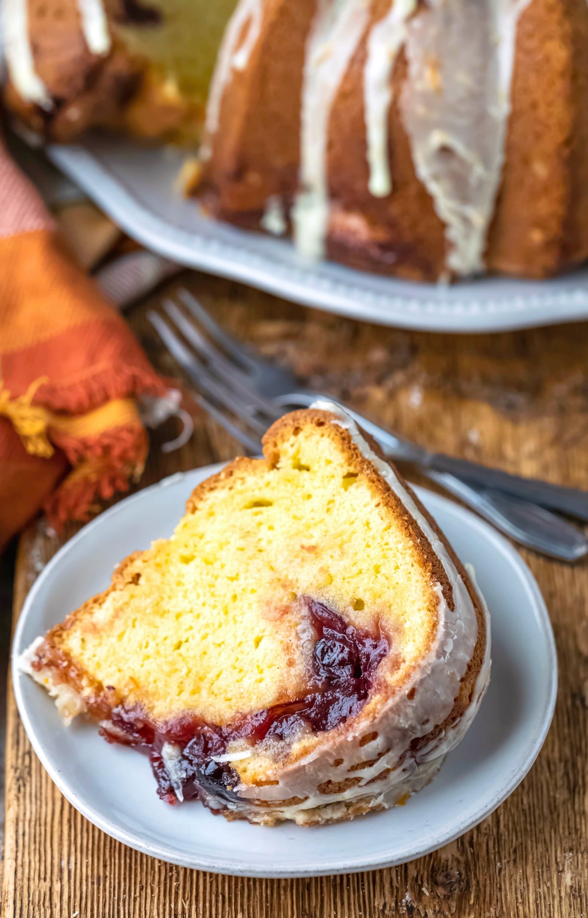 Slice of cranberry orange pound cake on a white plate