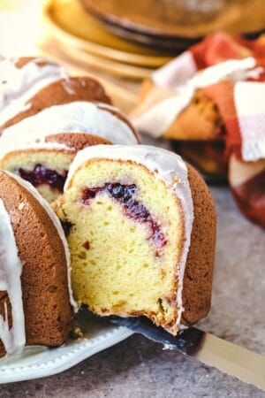 Knife cutting a slice of cranberry orange pound cake