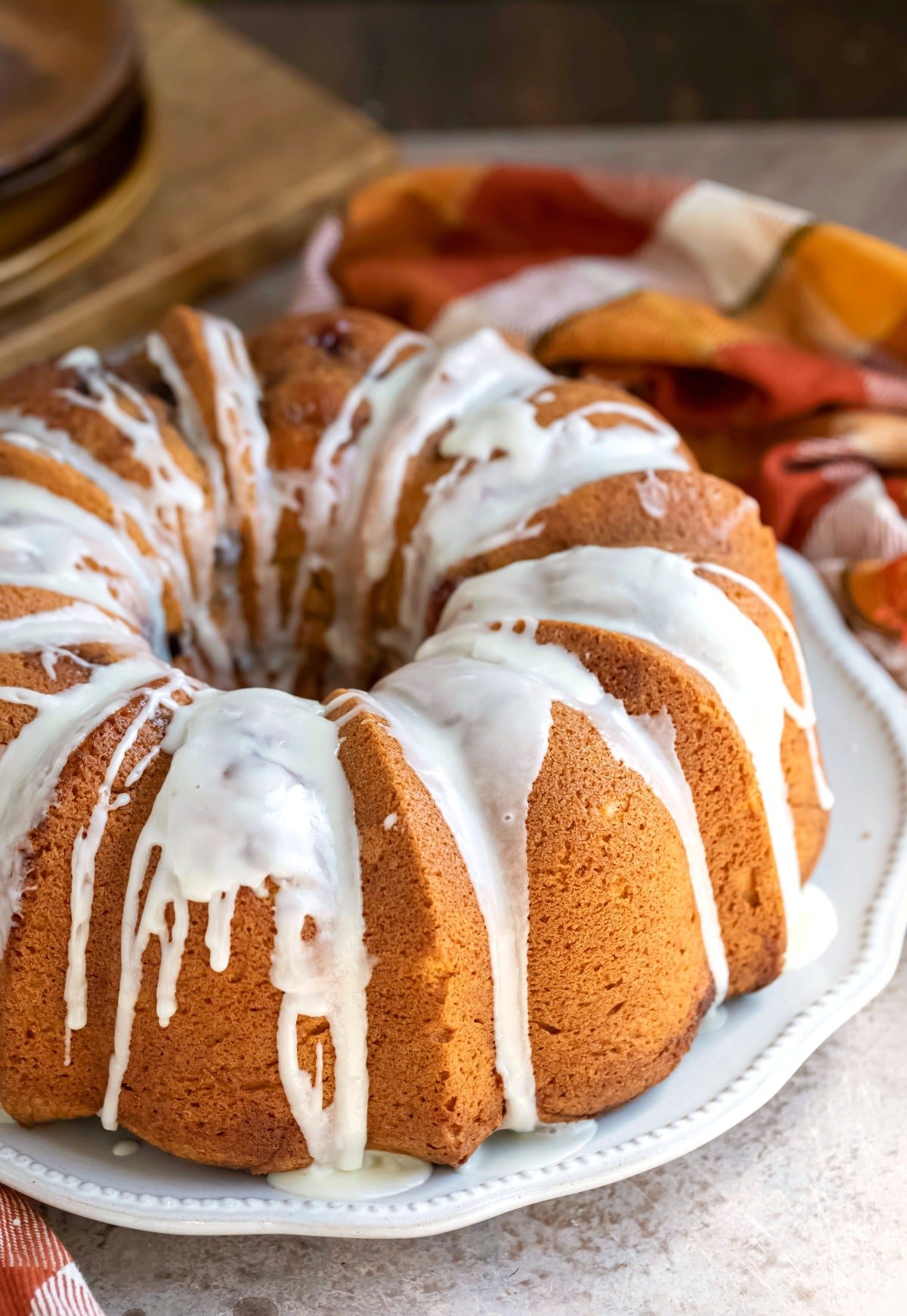 Glazed cranberry orange pound cake on a white platter